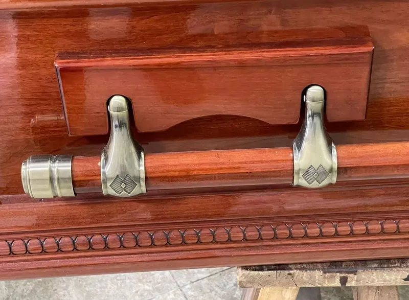 Coffin handles and lid fittings installed on a finished casket, produced by Virtue Hardware Co., Ltd