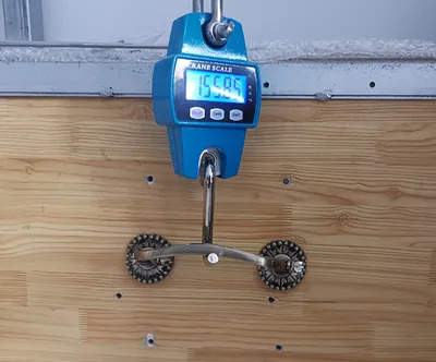 Coffin handle mounted on the lift weight testing rig at the Virtue Hardware factory