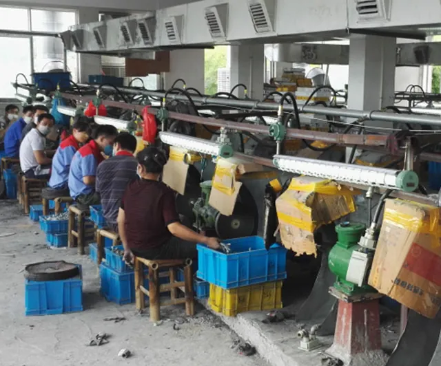 Workers hand polishing zamak castings at the Virtue Hardware factory